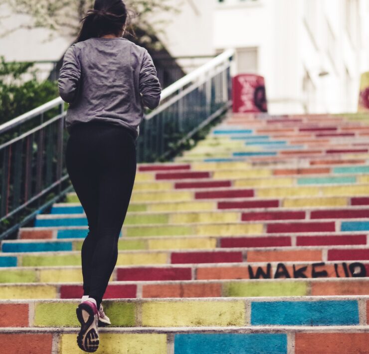 woman running upstair in room city wellness