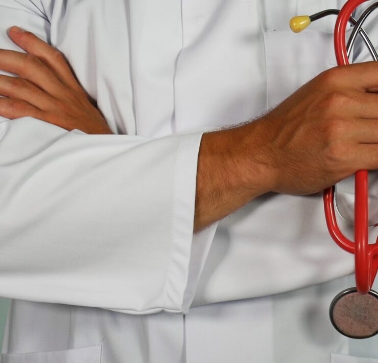 doctor holding red stethoscope