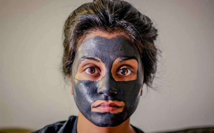 woman with gray facial mask, skin,