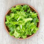 green vegetable on brown round plastic bowl lettuce