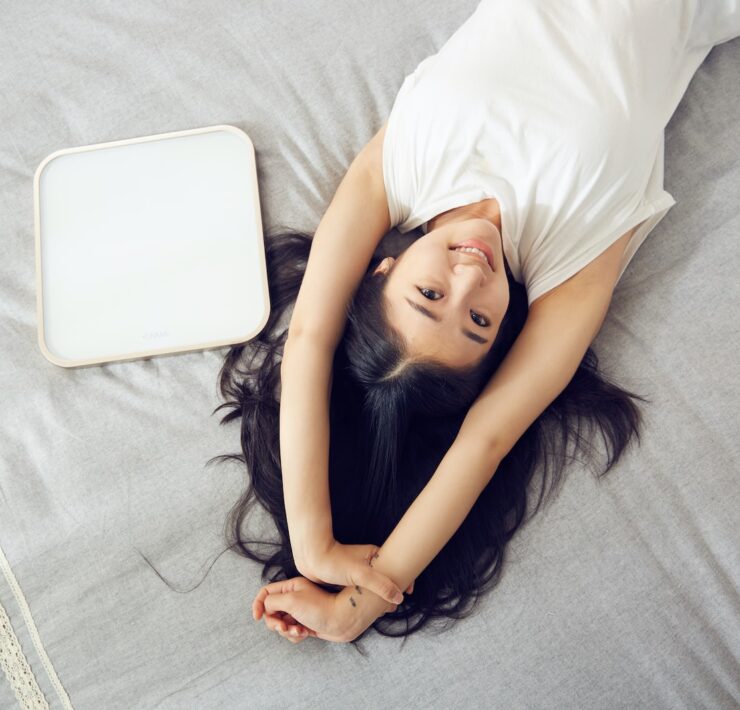 woman laying on bed girl wellness happiness