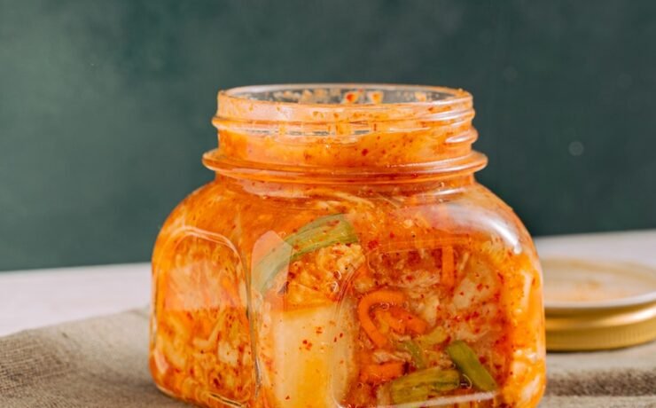 Clear Glass Jar with Kimchi beside the Wooden Chopsticks fermented vegetables