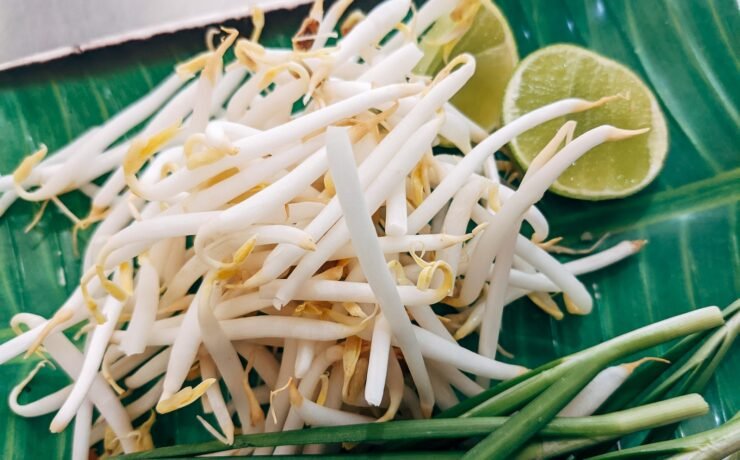 a close up of a plate of food on a table sprouts