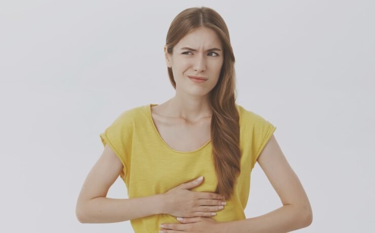 sick girl stomach intestine bad gastric reflux acidity inflammation feeding