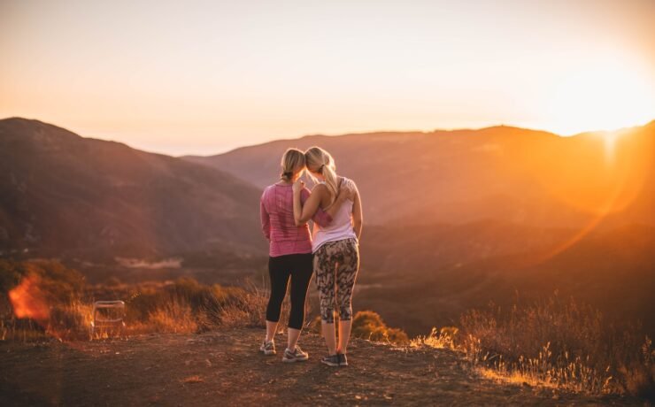 two women standing on moutain