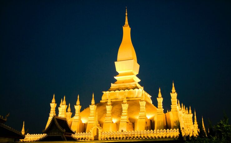 a large white building with a clock on it's side LUANG PRABANG laos asia