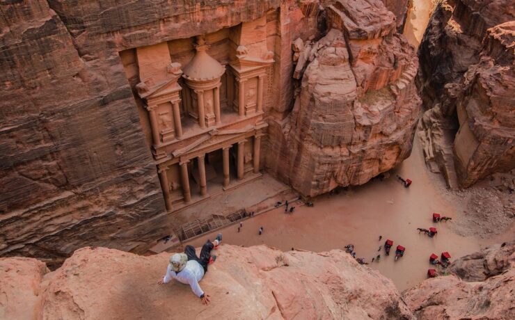 people walking on brown rocky mountain during daytime petra