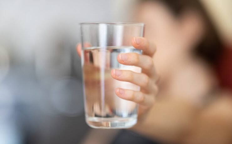 person holding clear drinking glass water