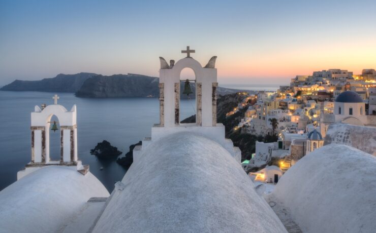 white concrete building near body of water during sunset santorini greece sea