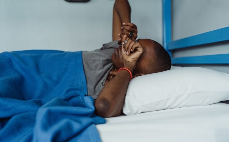 Woman in Gray T-Shirt Waking Up in Bed with Blue Blanket wake up bed