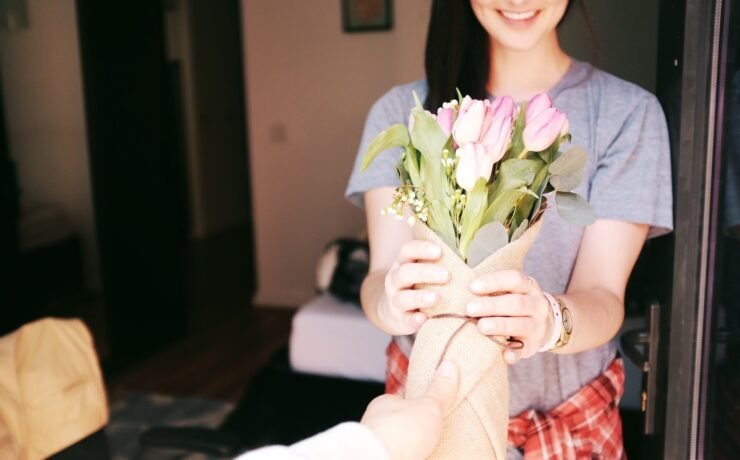 woman receiving a bouquet of flowers