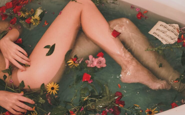 bathtub with water and flowers