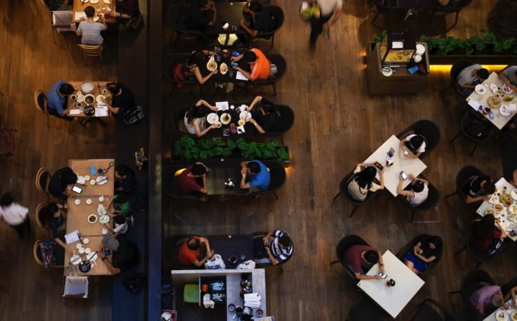 people sitting at tables in a restaurant