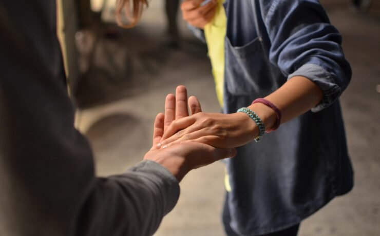 high five shaking hands man and woman