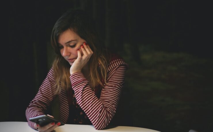 sitting girl looking at mobile phone