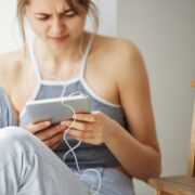 tired woman looking and scrolling at a tablet