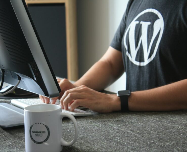 person in black and white t-shirt using computer