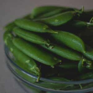 A close-up shot of fresh green beans in a glass bowl, highlighting their natural freshness.