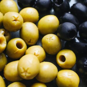 Close-up view of fresh green and black olives showing texture and color.