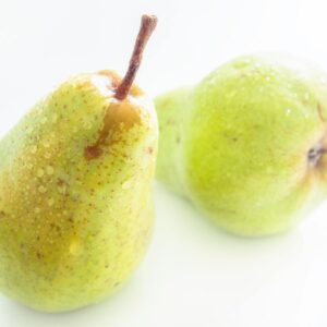 Close-up of fresh, juicy pears with dew drops, showcasing their freshness and vibrant color.
