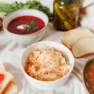 A diverse spread featuring Russian foods like borscht, sauerkraut, and caviar on a table.