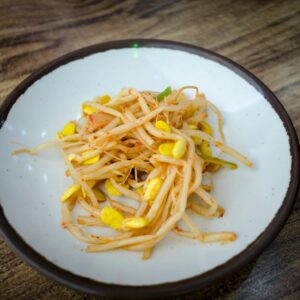 Delicious close-up of seasoned Korean soybean sprout side dish on a plate.