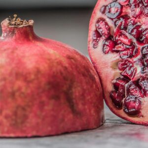 Vibrant close-up of a juicy pomegranate slice showcasing fresh seeds and rich color.