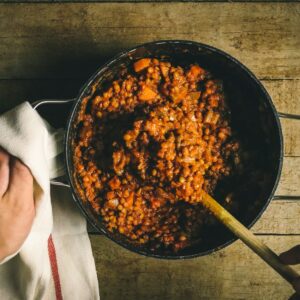 person holding stainless steel round tray with food