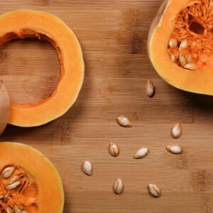 sliced pumpkin on brown wooden surface