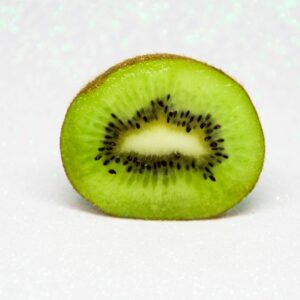 Close-up of a juicy kiwi slice showcasing its vibrant green color and unique texture.
