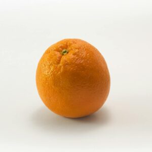 A single fresh orange isolated on a white background, symbolizing health and freshness.