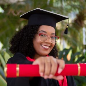 smiling woman wearing academic dress and black academic hat