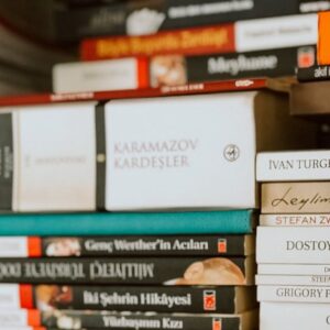 Vintage rangefinder camera on a pile of classic literature books.