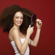 a woman holding a hair brush in her hand