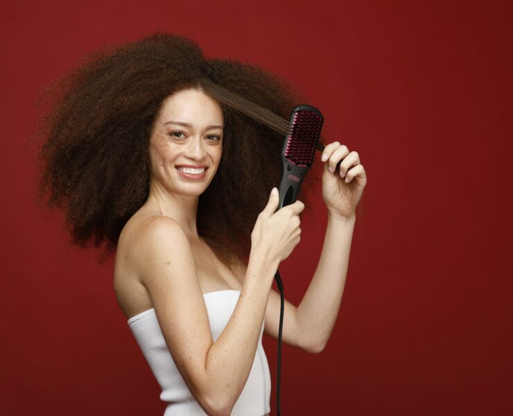a woman holding a hair brush in her hand
