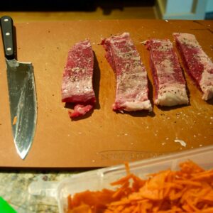 sliced meat on brown chopping board