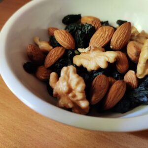brown and black nuts on white ceramic bowl