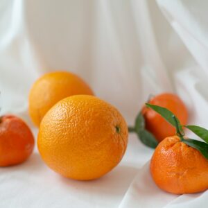 orange fruit on white textile