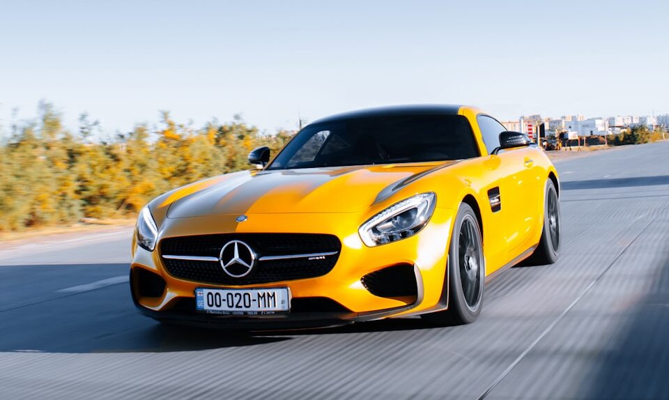 yellow porsche 911 on road during daytime