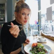woman in black long sleeve shirt eating