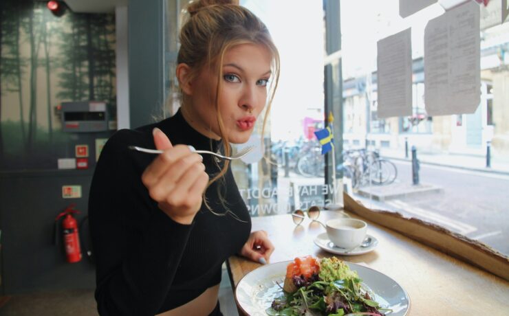 woman in black long sleeve shirt eating