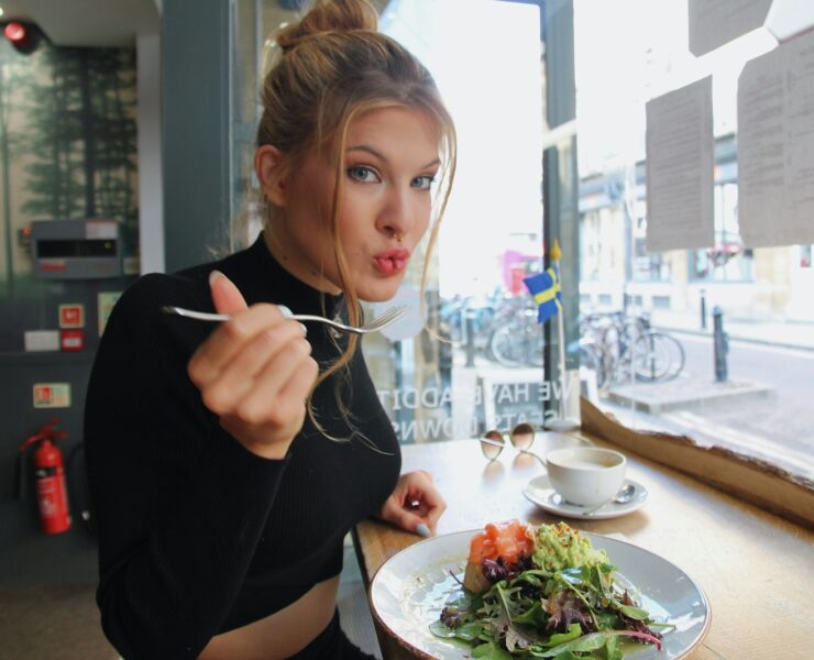 woman in black long sleeve shirt eating