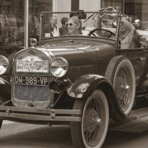 Vintage car with people observing.