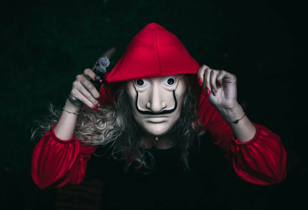 a person wearing a mask and a red hat