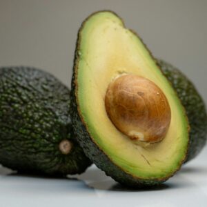 an avocado cut in half on a table