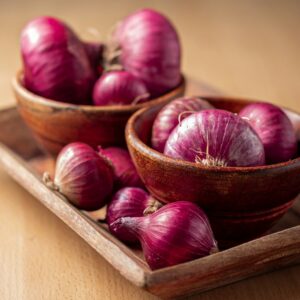 red onion on brown wooden tray