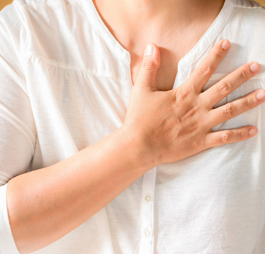 Woman is clutching her chest