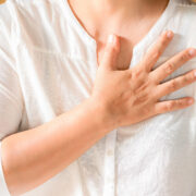 Woman is clutching her chest