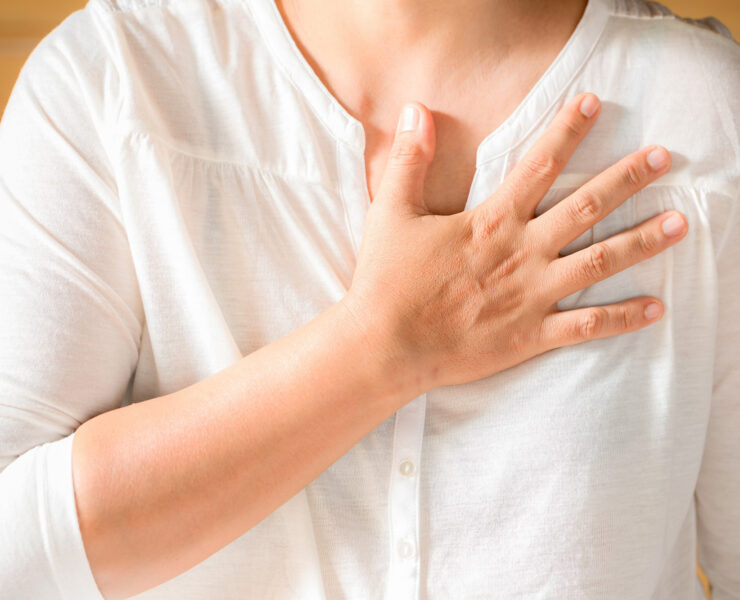 Woman is clutching her chest